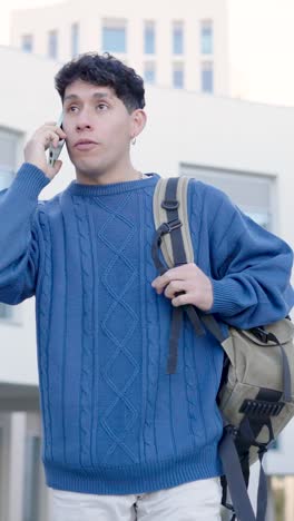 young student talking on phone while walking. vertical