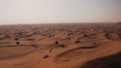 vehicles speeding through vast desert landscape on a hot weather