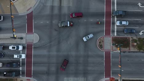 A-rotating-aerial-view-of-a-downtown-intersection-during-morning-rush-hour