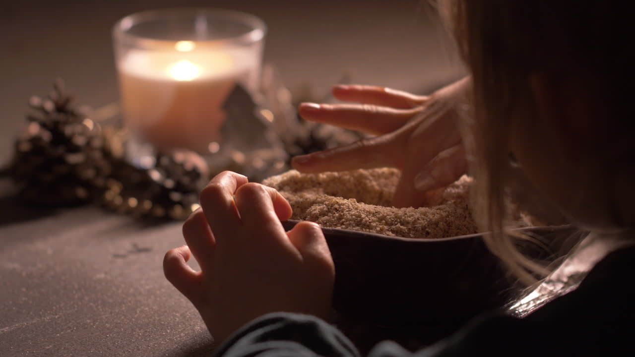 Over shoulder, little child making hole in wheat flour mix, preparing for baking