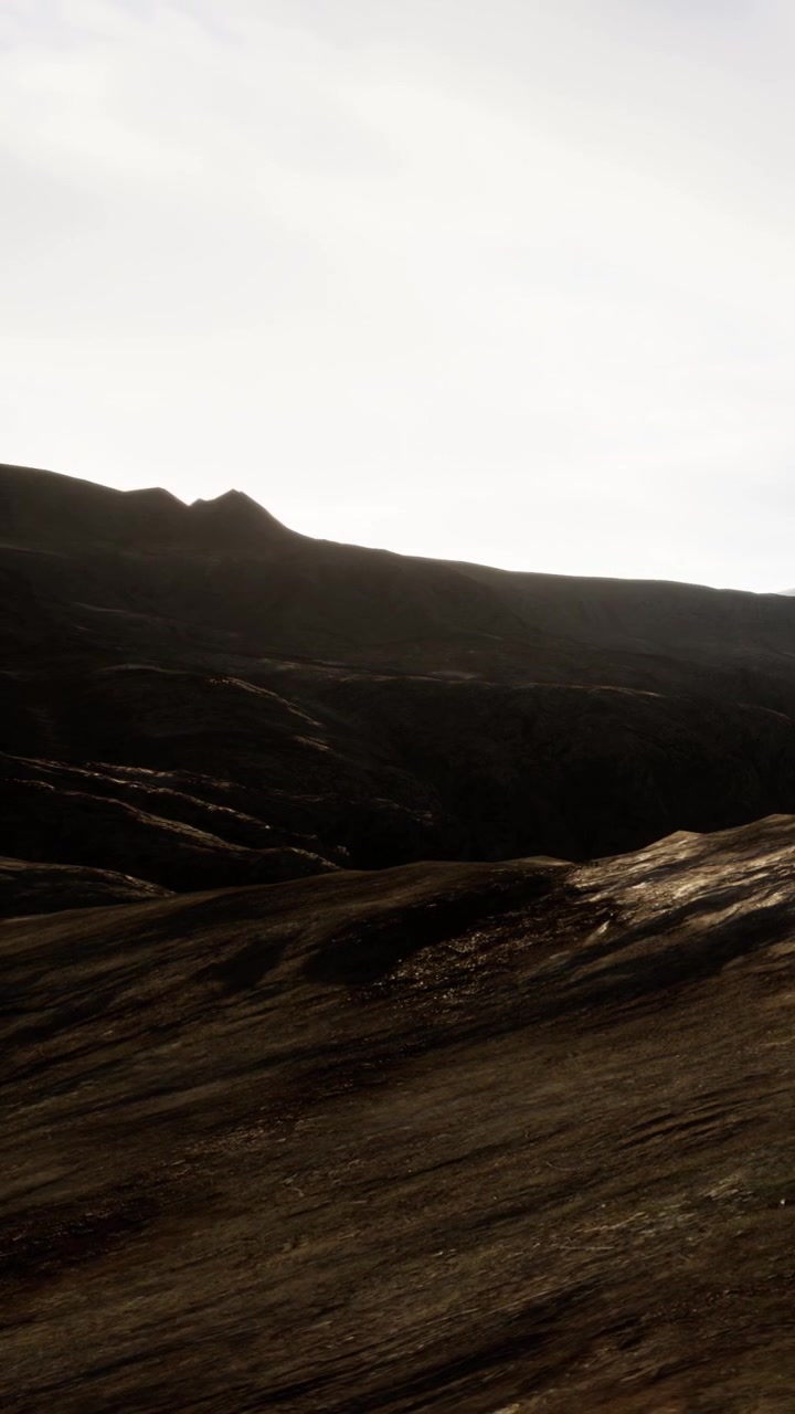 Sunlight shines on the surface of rocky mountains