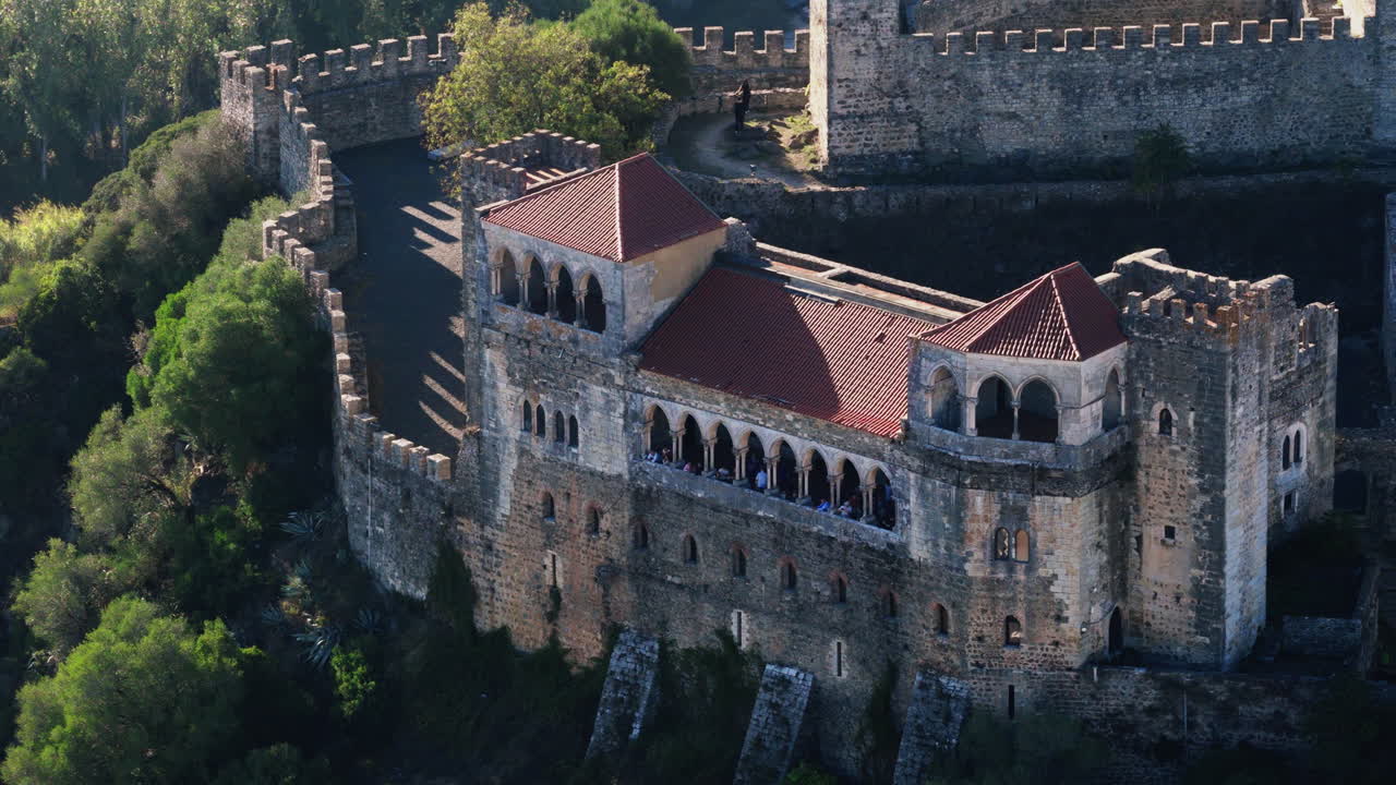 Castelo de Leiria aerial wide shot, gentle forward drift with fortress centered and cityscape rolling behind