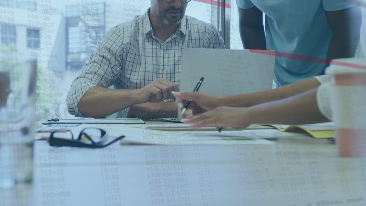 Man reaching for pen, business team reviewing and writing on docs, red lines annotating near hands