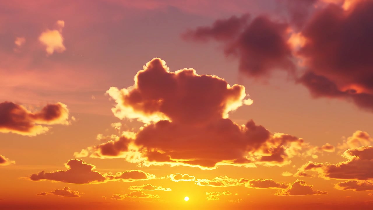 Beautiful orange sunset sky with dramatic glowing clouds
