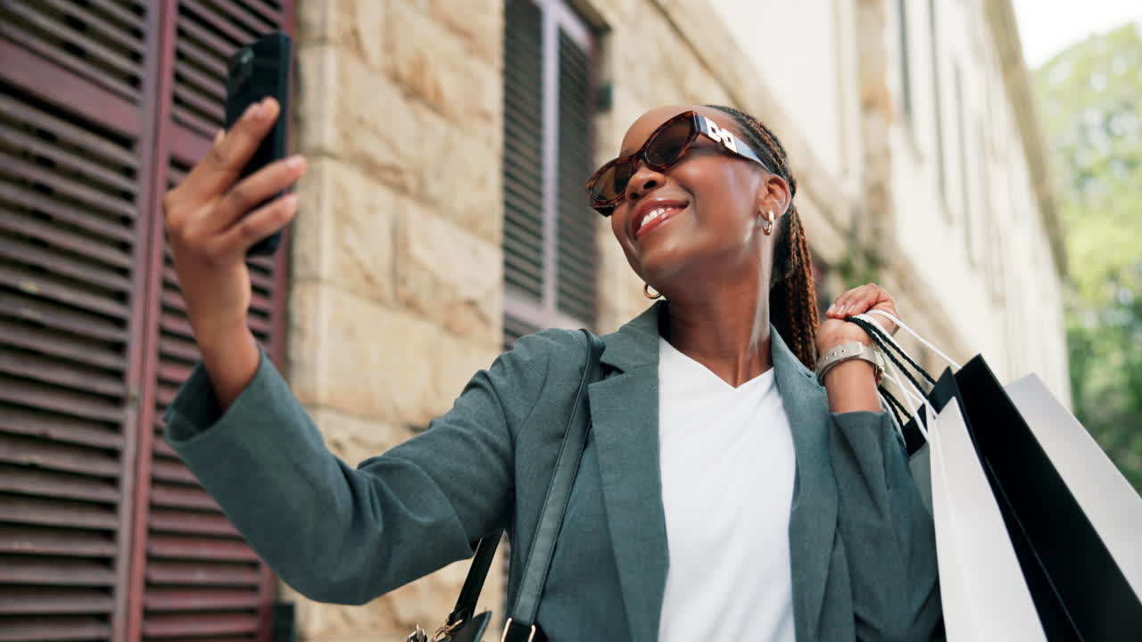 Woman Taking Selfie with Shopping Bags on City Street
