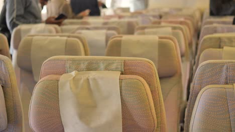 asientos de avión de pasajeros purpurados vacíos en la cabina,