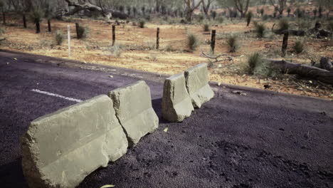 road barriers disrupt traffic in a remote desolate landscape