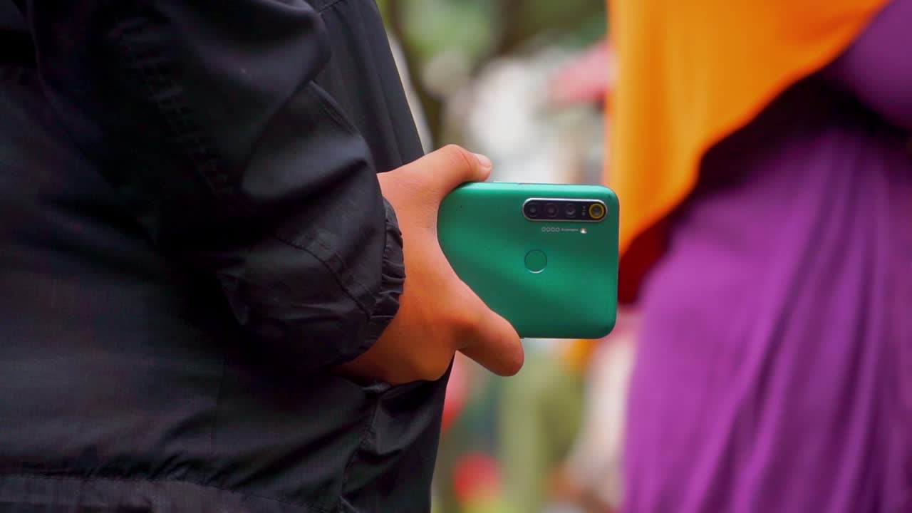 mano mand con chaqueta negra está sosteniendo el teléfono inteligente