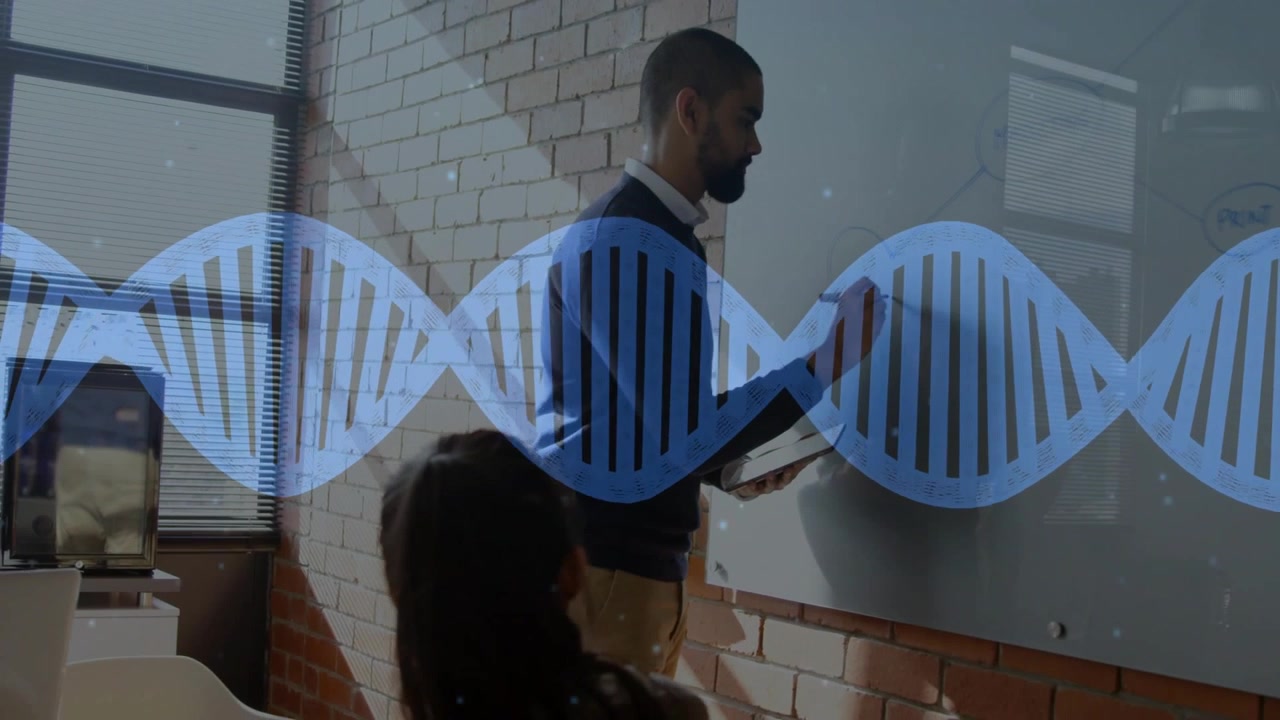Male presenter checking tablet, writing on board and activating DNA overlay while teaching genetics