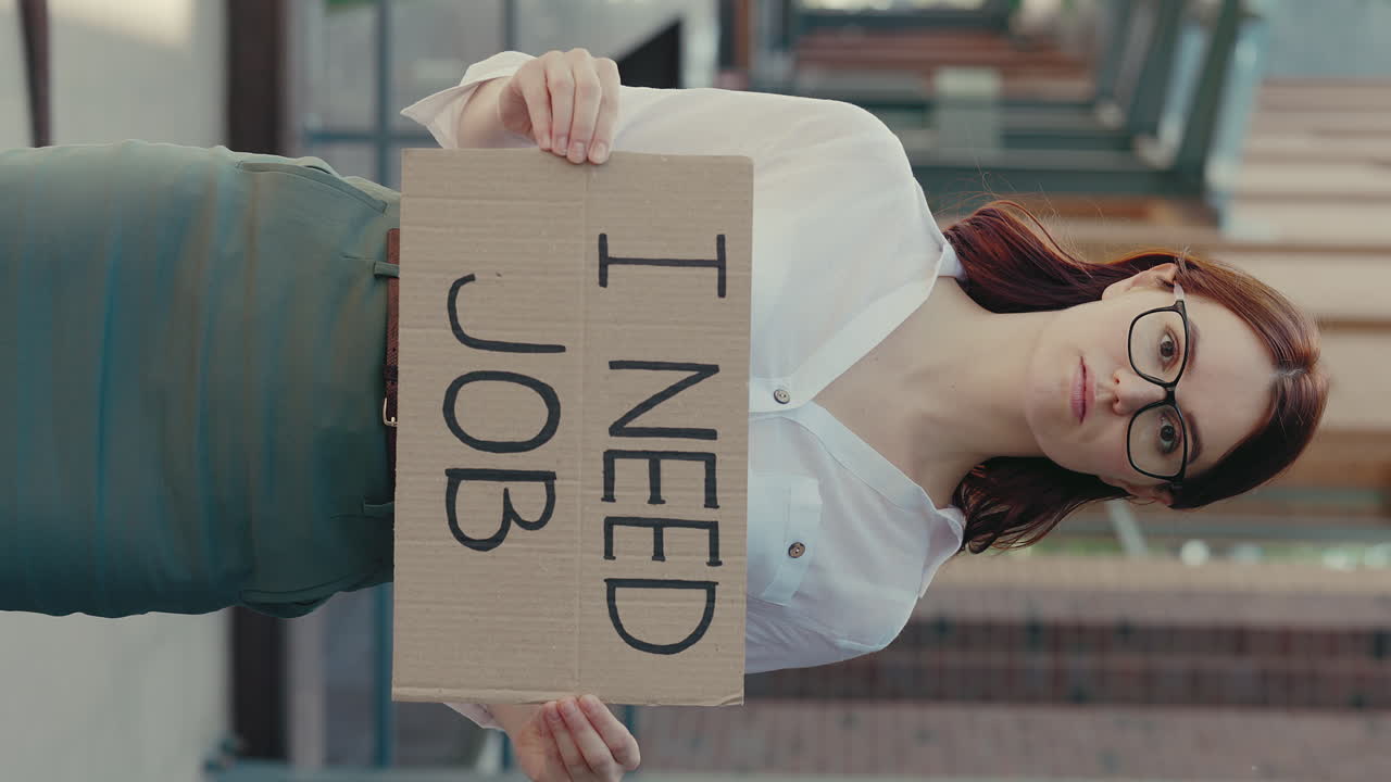 Woman Holding 'I Need Job' Sign