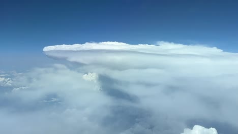 a pilot’s perspective from a jet flying near a huge storm cloud at 120000mhigh