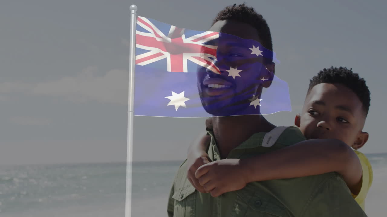 On beach, father and child playing with Australian flag animation overlay