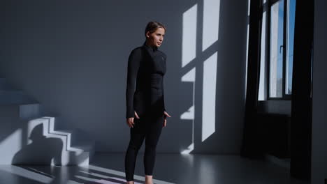 woman practicing yoga in studio