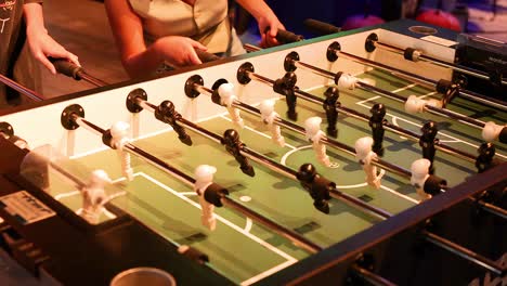 players engaged in a lively foosball game