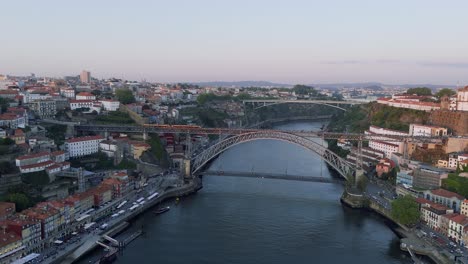 fly towards luís i bridge, train passing by, summer evening in porto