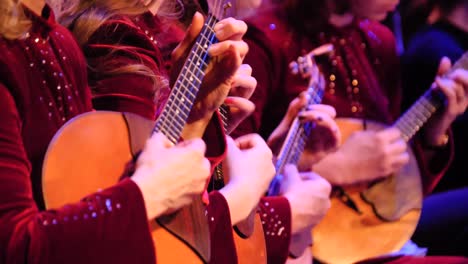 women playing guitars in a performance