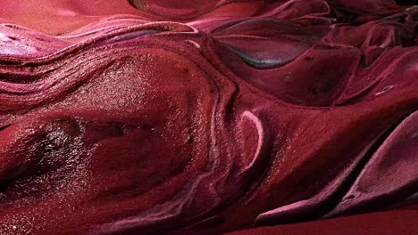 abstract animation of flowing dark red and brown viscous liquid with shimmering highlights, organic texture