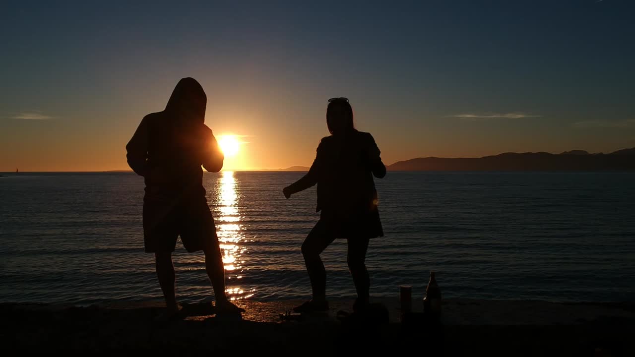 Dancing couple at sunset on the beach