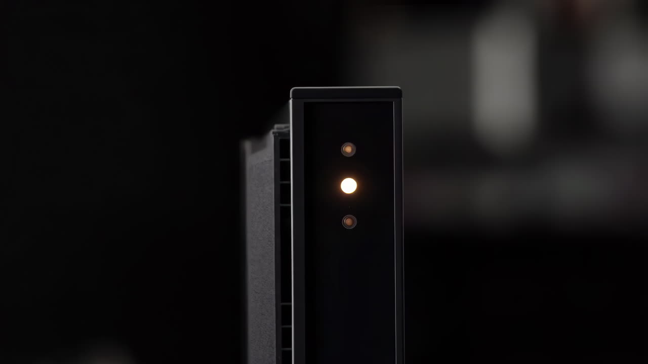 Close-up of a Black Electronic Device with Glowing Indicator Lights