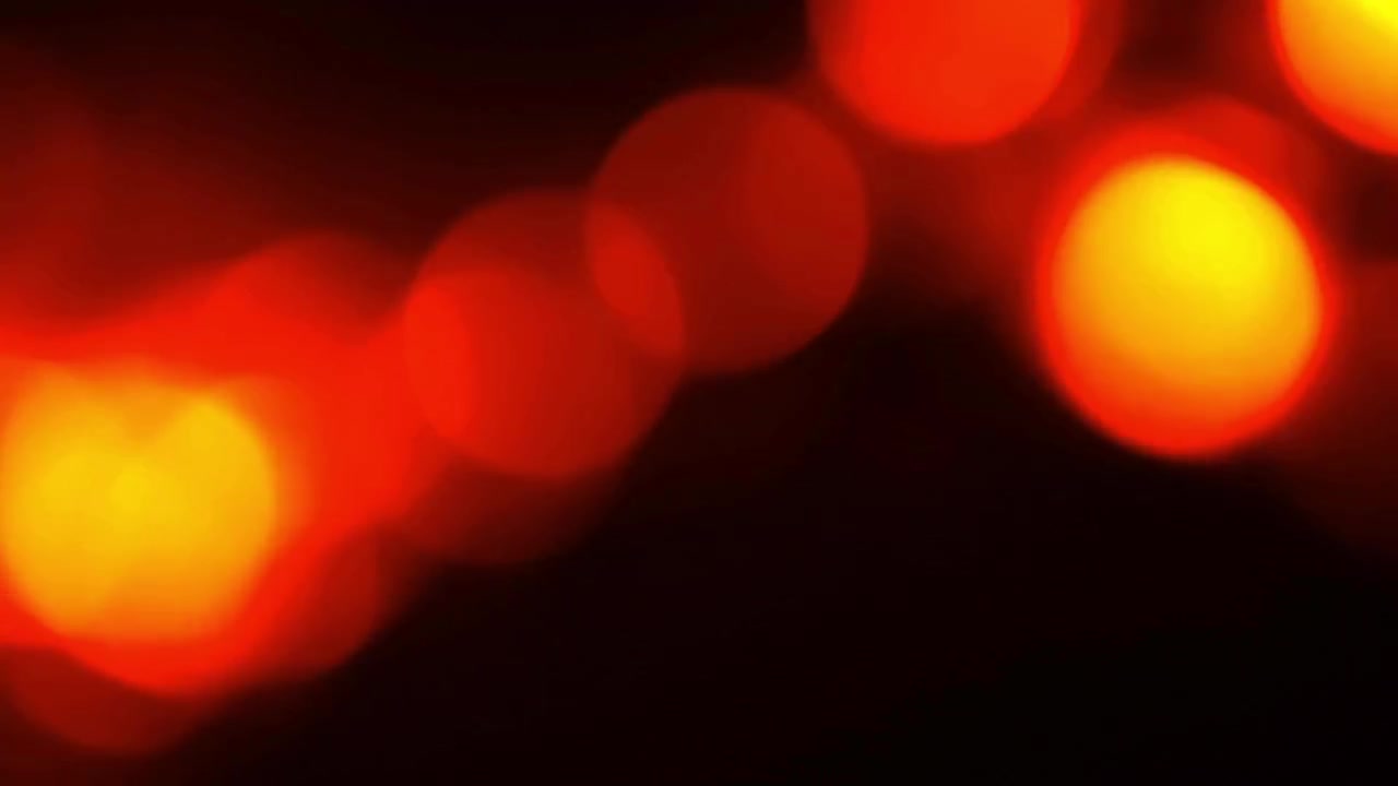 Orbes de Luz Bokeh Abstratas Vermelhas e Amarelas em Fundo Preto
