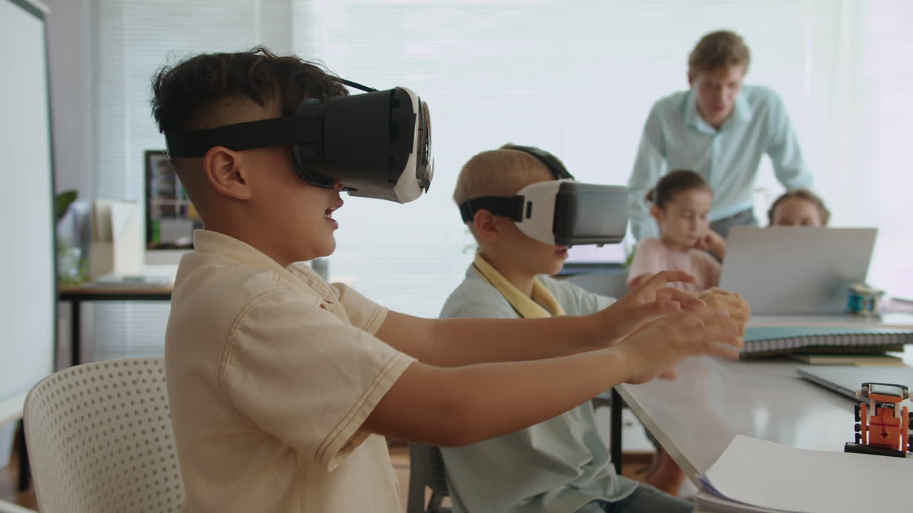 Boys Playing Online Game in VR Glasses at IT Lesson