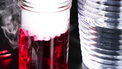a red liquid in a jar emits white smoke, creating a striking visual effect.
