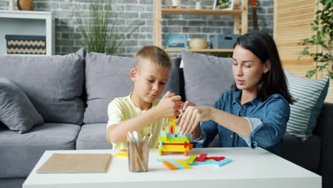 mother and son playing with wooden blocks