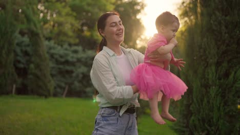 happy mother and daughter playing in the park