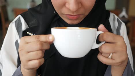 woman enjoying a latte in a cafe