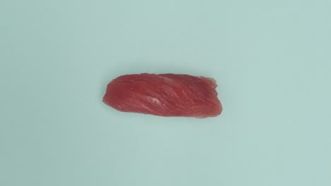 un rollo de sushi girando sobre un fondo azul