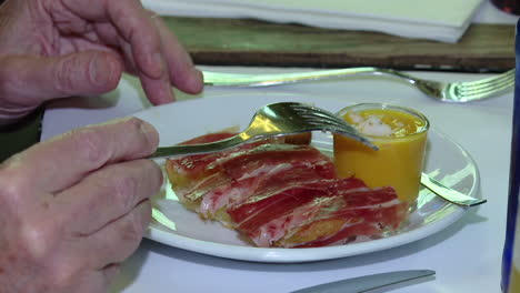 tasting spanish tapas with ham and soup