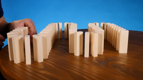 domino effect concept with wooden blocks