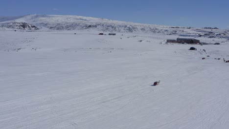 Drone-of-horse-dragging-carriage-over-frozen-cildid-lake-in-Turkey