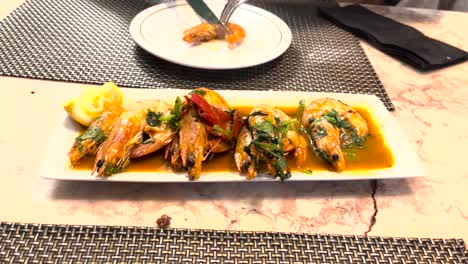 garlic and pepper prawns, a typical lisbon delicacy, featuring succulent prawns cooked with aromatic garlic and spicy pepper flavours