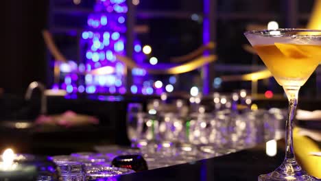 nighttime cocktail at a bar with christmas lights