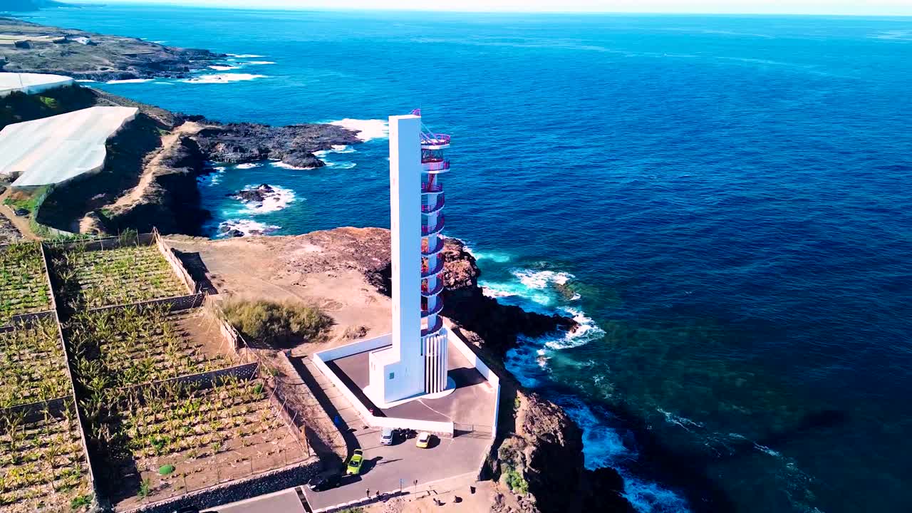 Buenavista lighthouse overlooking the ocean and surrounding landscape, aerial view