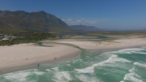 hermanus beach with waves rolling in and massive mountains rising in the background