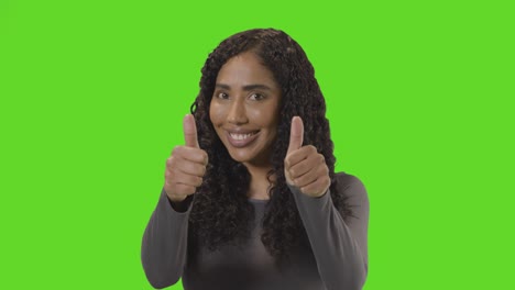 Studio-Portrait-Shot-Of-Woman-Giving-Double-Thumbs-Up-Sign-Against-Green-Screen