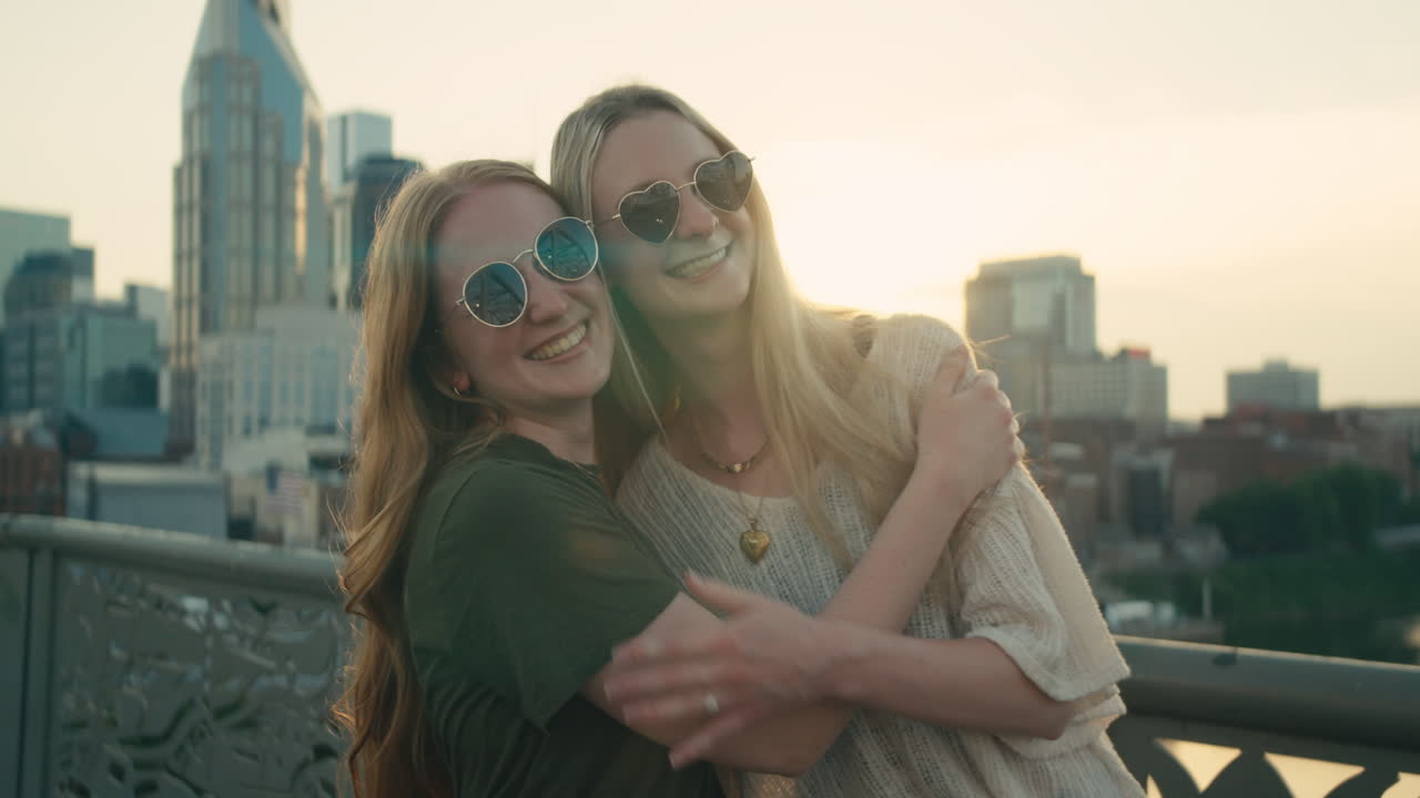 Two friends embracing in front of Nashville skyline