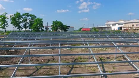 building of innovative solar power station in nature. metal basis for future solar panels on the field. motion camera back.