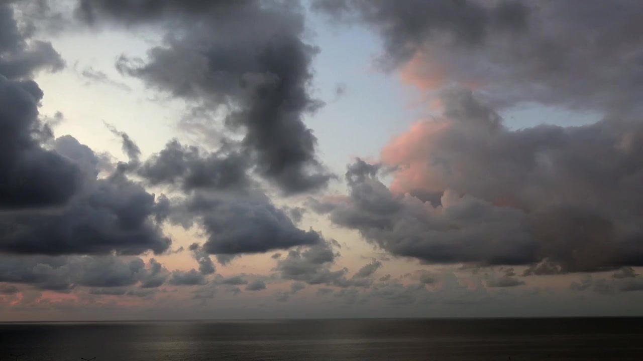Dark Storm Clouds Gathering Over the Ocean at Sunset