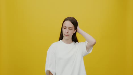 teenager posing against yellow background