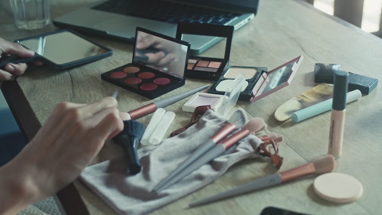 Woman Applying Makeup at a Table