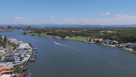 a ferry travels along a scenic river