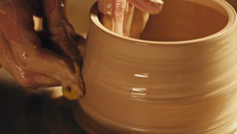 pottery artist working on a clay vessel