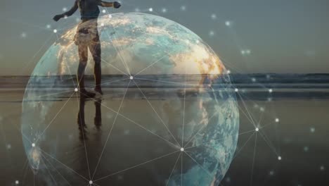 animation of globe and connections over caucasian woman walking on beach at sunset