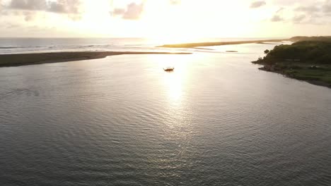 the-aerial-view,-the-boats-sailing-in-the-lagoon-at-sunset-looks-very-beautiful