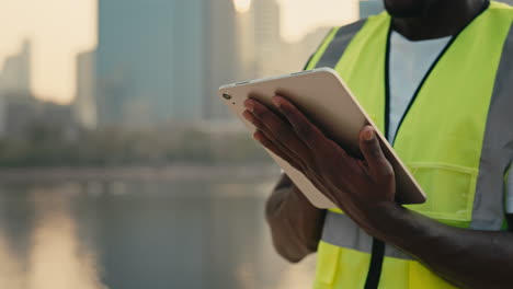 construction worker using a tablet in the city