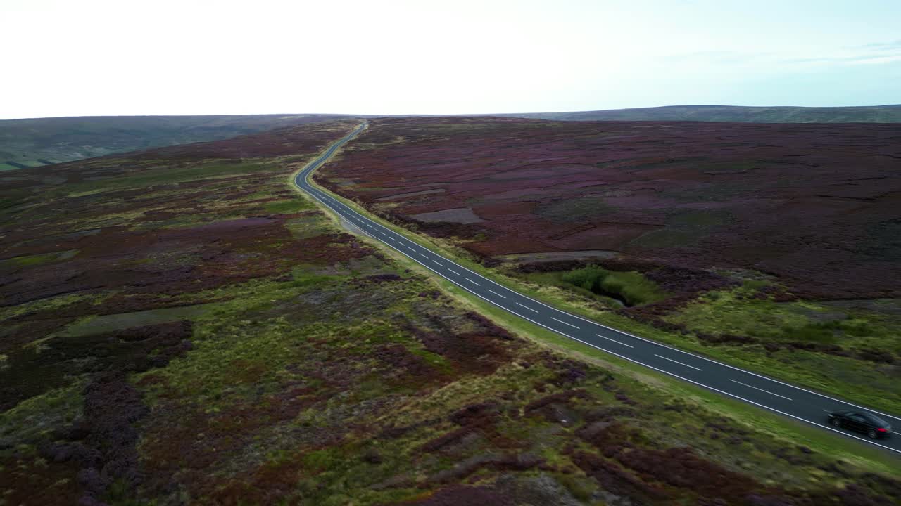 aerial view of sport car driving along scenic road in North Yorkshire Moors National Park England UK