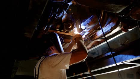 male mechanic using flaming torch 4k